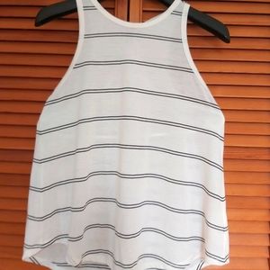 Cream swing tank top with split back.